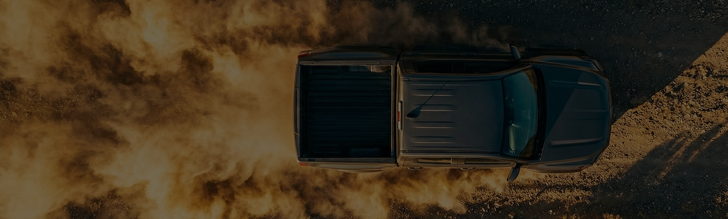 Bakkie driving through dust